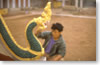 Painting the nagas that guard the entrance to the Ong Theu wat in Vientiane