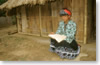 A Yao shaman reading the sacred book (Samneua province)